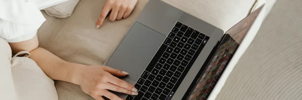 A user is browsing online using a laptop.